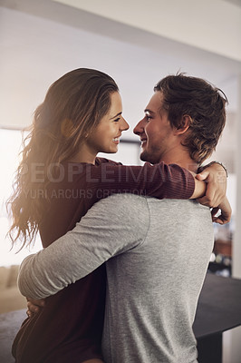Buy stock photo Woman, man and hug for love, care and quality time together with commitment to relationship at home. Happy young couple, hugging and romance of lovers, smile and relax with trust of partner in house