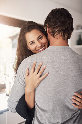 Buy stock photo Portrait of happy woman, man and hug of love, care and quality time together for commitment to relationship at home. Young couple, smile and hugging for romance, trust and relax with partner in house