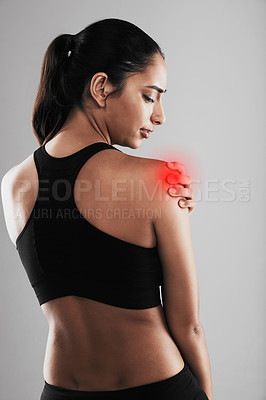 Buy stock photo Rearview shot of a young woman suffering from back pain