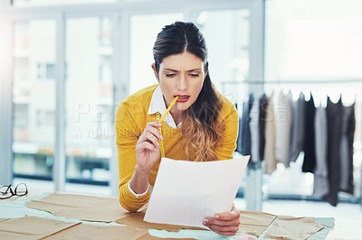 Buy stock photo Woman, fashion design and paper with pattern for project brainstorming or textile, clothes or seamstress. Female person, small business and confused for manufacturing fabric, planning or creativity