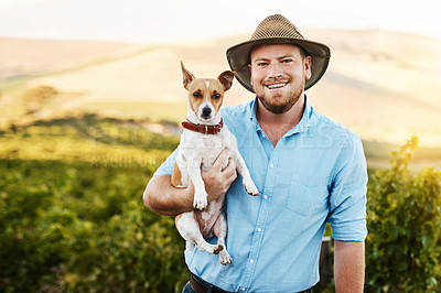 Buy stock photo Portrait of a farmer holding his dog in a vineyard
