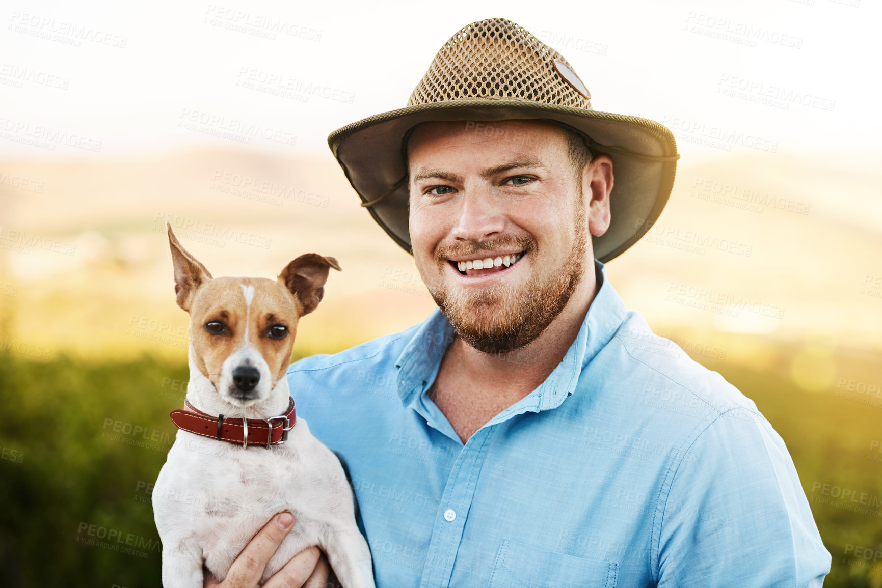 Buy stock photo Happy, farm and portrait of man with dog for pet training in agro, sustainable or nature environment. Field, smile and male agriculture worker bonding with jack russell puppy in Texas countryside.