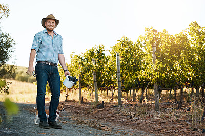 Buy stock photo Portrait of a farmer and his dog standing in a vineyard