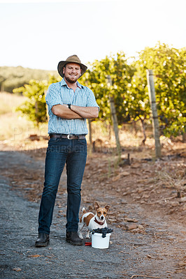 Buy stock photo Portrait of a farmer and his dog standing in a vineyard