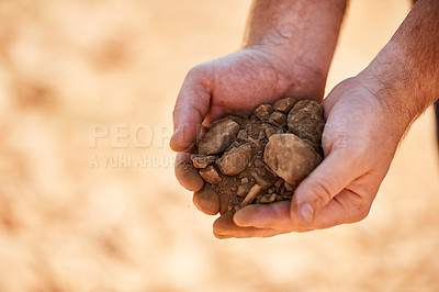 Buy stock photo Closeup shot of a farmer holding soil and rocks in his hands