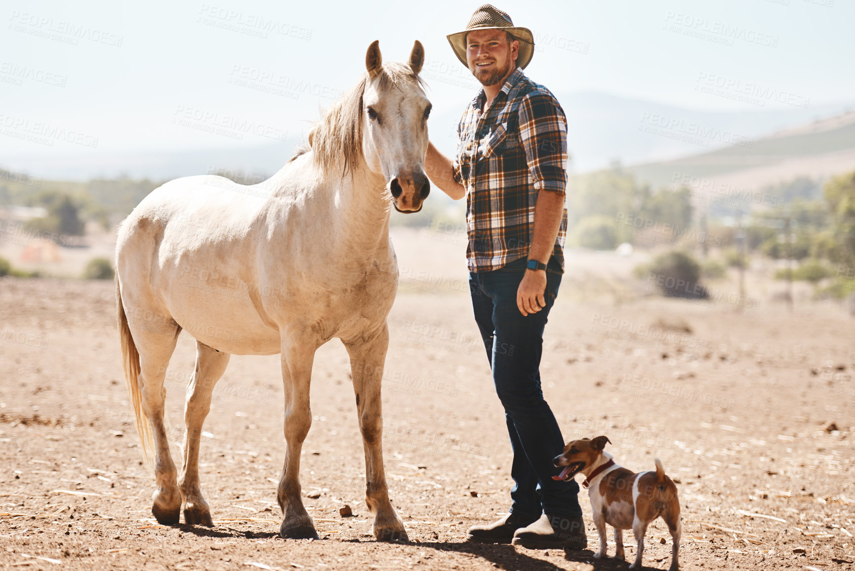 Buy stock photo Portrait of a farmer standing with a horse on a ranch