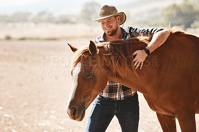 Buy stock photo Shot of a farmer standing with a horse on a ranch