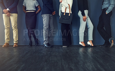 Buy stock photo Cropped studio shot of a group of well dressed businesspeople standing in line while waiting to be interview