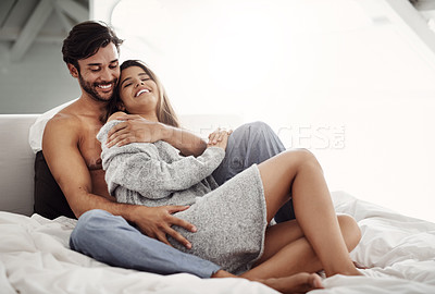 Buy stock photo Shot of an affectionate young couple in their bedroom at home