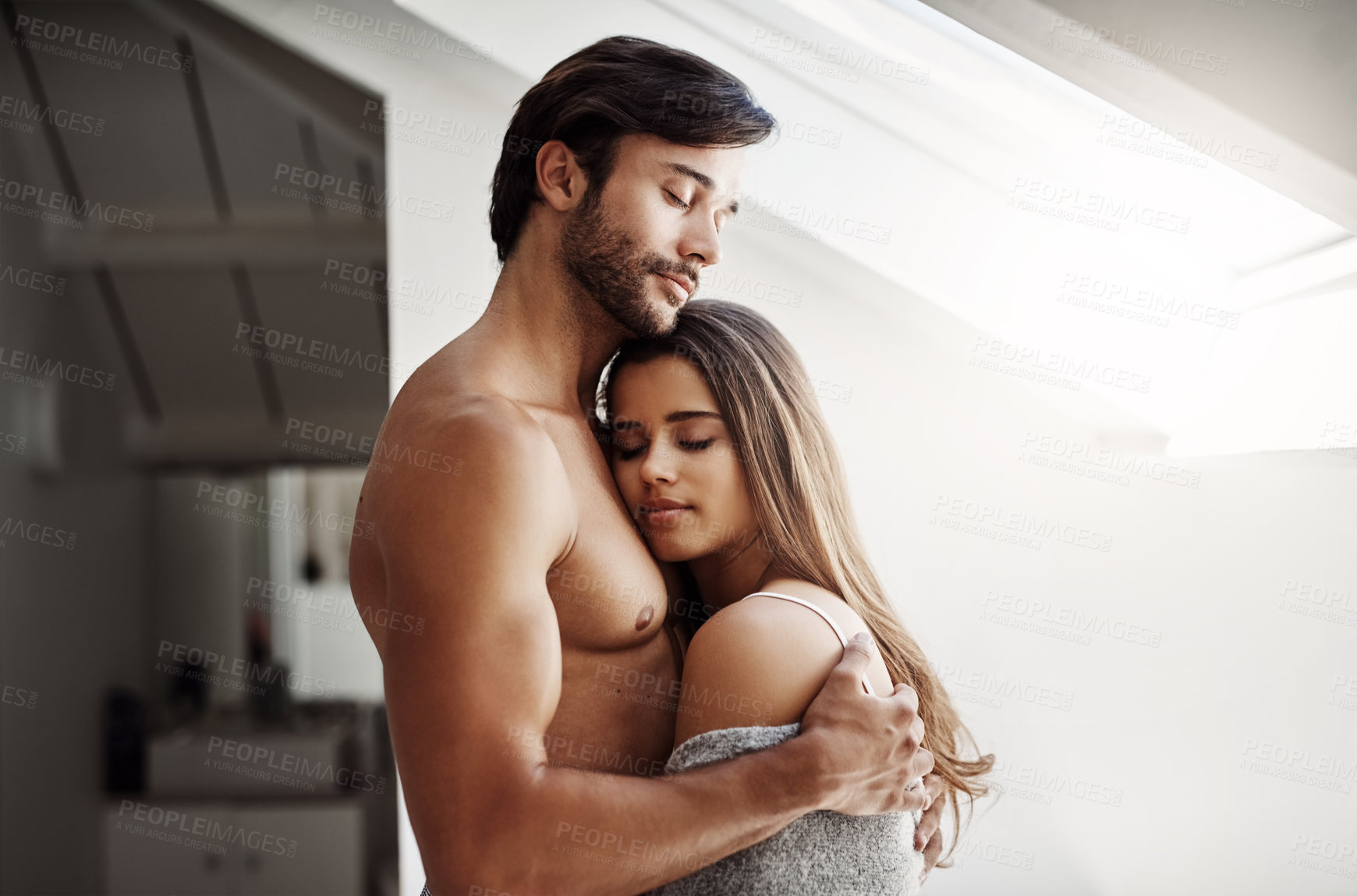 Buy stock photo Cropped shot of an affectionate young couple in their bedroom at home