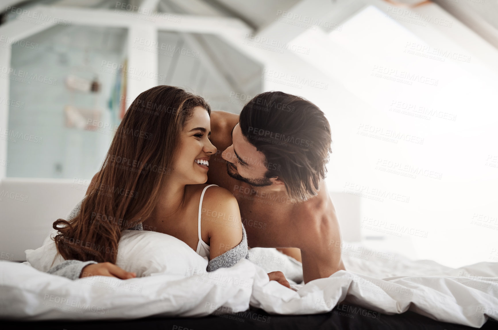Buy stock photo Shot of a young couple in their bedroom at home