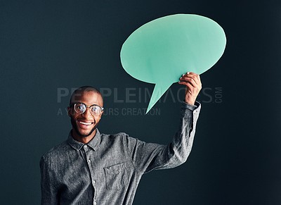 Buy stock photo Studio shot of a handsome young man holding a speech bubble