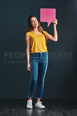 Buy stock photo Studio shot of a beautiful young woman holding a speech bubble