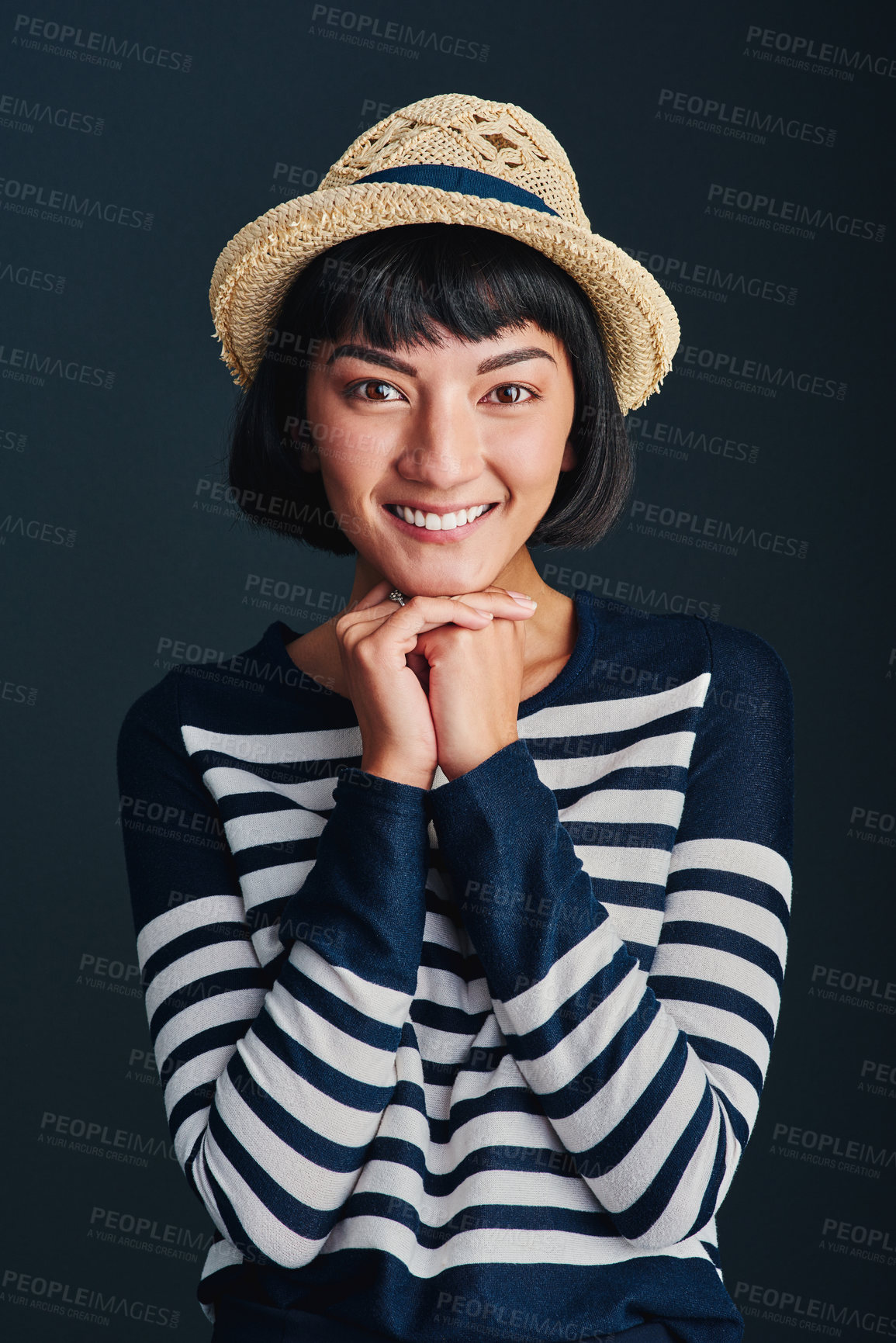Buy stock photo Studio shot of an attractive young woman against a dark background