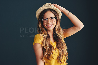 Buy stock photo Studio shot of an attractive young woman against a dark background