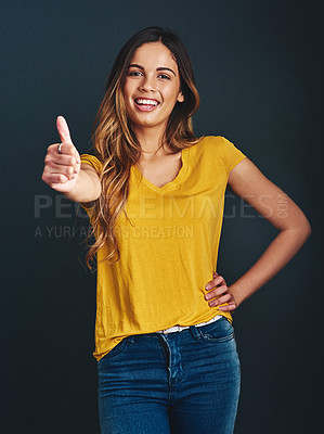 Buy stock photo Thank you, portrait and a woman with a thumbs up for success, agreement and yes sign. Smile, like and a lady with a hand gesture isolated on a dark background in a studio for motivation and a goal