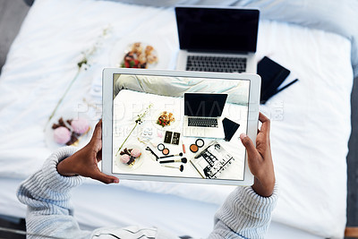 Buy stock photo High angle shot of an unrecognizable woman taking a photo of objects on her bed in her bedroom at home