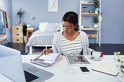 Buy stock photo Cropped shot of an attractive young woman working at home