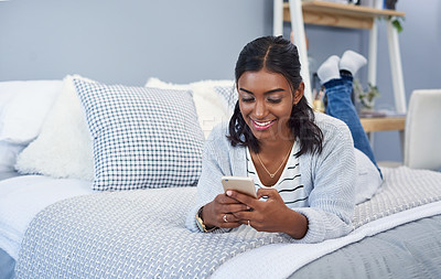 Buy stock photo Indian woman, smile and cellphone or bed relax in home for social media browsing, meme or notification. Female person, smartphone and online shopping from apartment or rest, connection or internet