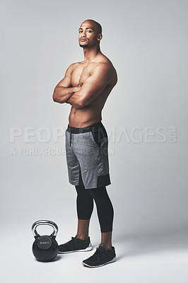Buy stock photo Black man, portrait and kettlebell in studio, confidence and shirtless for workout or exercise. Male person, athlete and weightlifting for muscle progress on gray background, tough and challenge