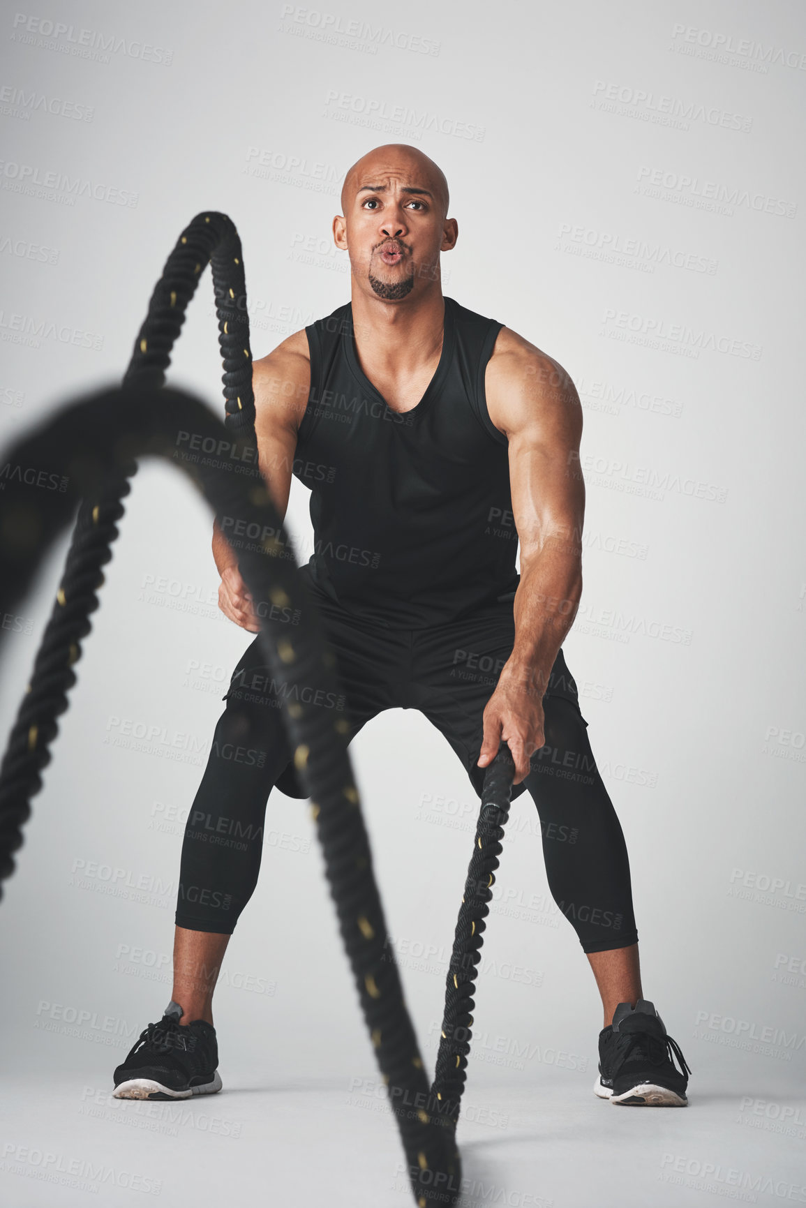 Buy stock photo Sports, black man and battle rope for fitness, strength and building of muscle, power and endurance. Speed, action and person in grey background, gym and resilience of athlete for exercise or workout