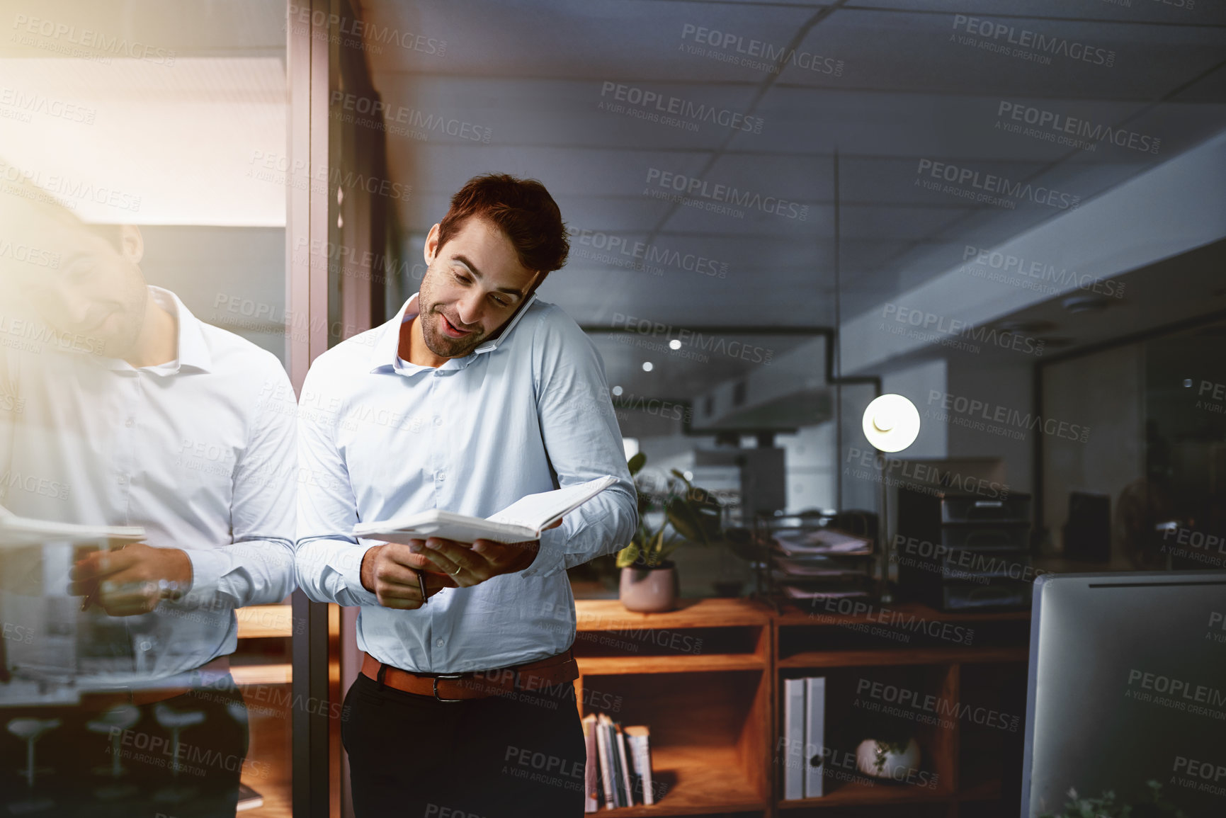 Buy stock photo Office, businessman and notes with phone call for listening, communication and planning with smile at night. Workplace, male person or consultant with book for writing, information and working late