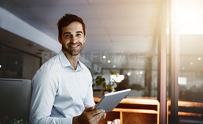Buy stock photo Portrait of a young businessman working late on a digital tablet in an office