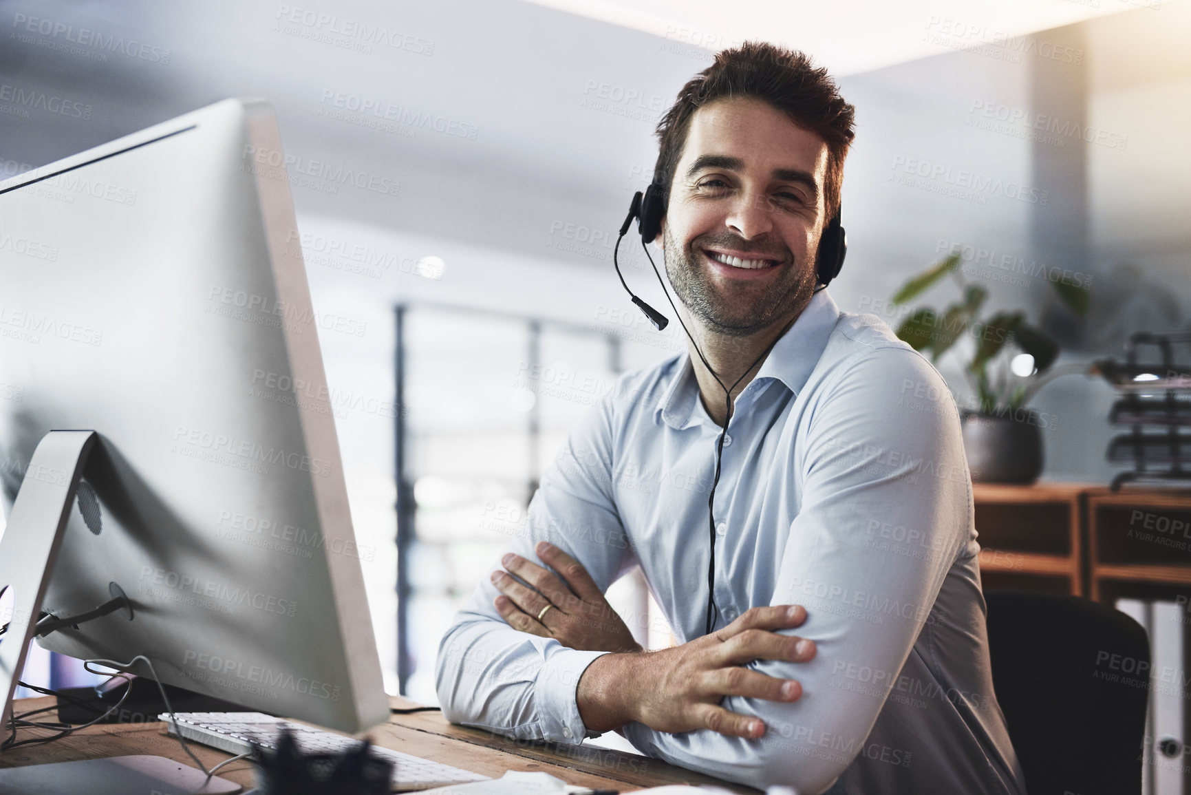 Buy stock photo Portrait of a young call centre agent working late in an office