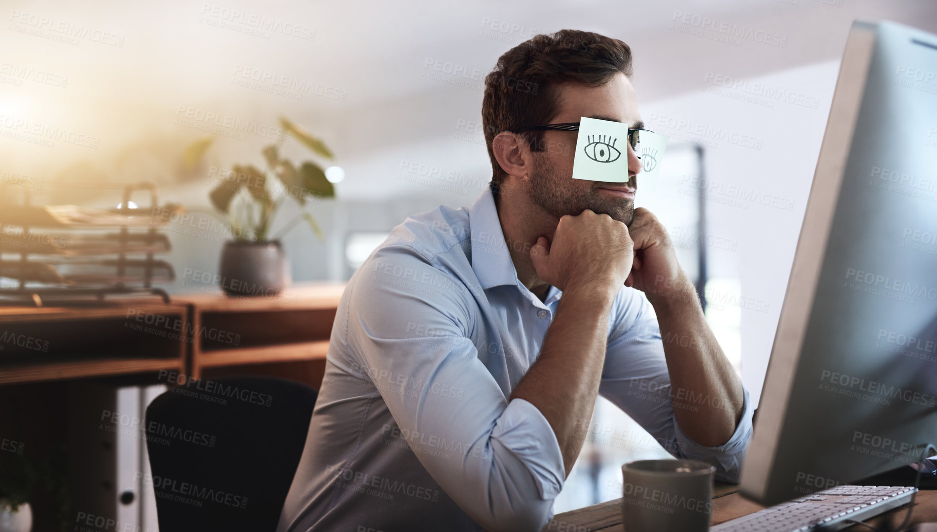 Buy stock photo Shot of a young businessman working late in an office with adhesive notes covering his eyes