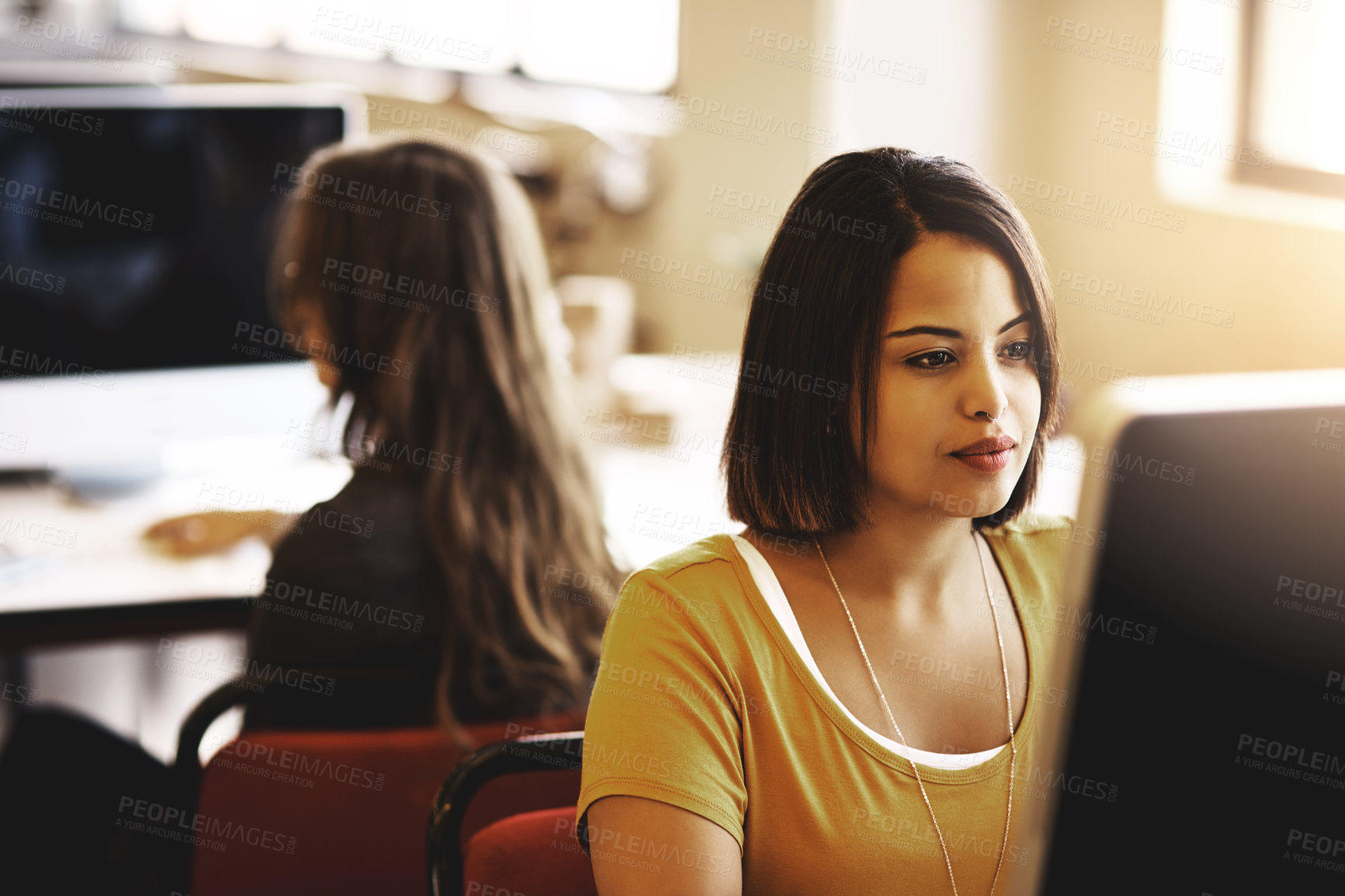 Buy stock photo Cropped shot of a businesswoman working on a computer in an modern office