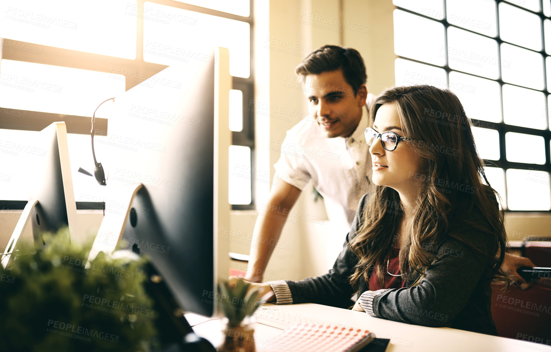 Buy stock photo Cropped shot of colleagues discussing something on a computer