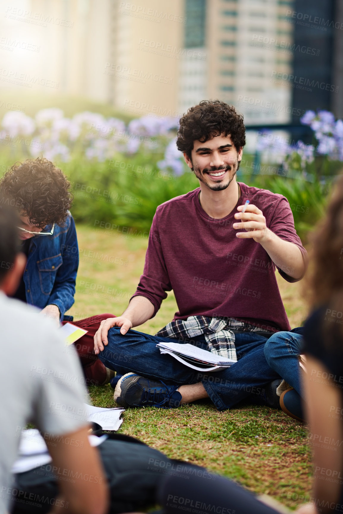 Buy stock photo Cropped shot of a group of college students having a discussion while sitting in a circle outside