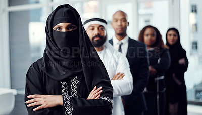 Buy stock photo Cropped portrait of an attractive young arabic businesswoman standing at the head of a line of her colleagues