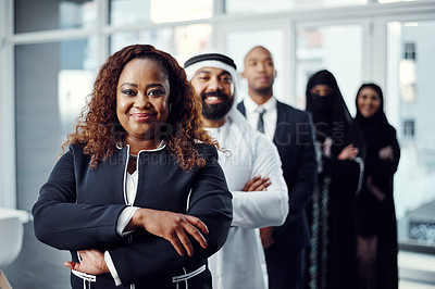 Buy stock photo Cropped portrait of an attractive young businesswoman standing at the head of a line of her colleagues