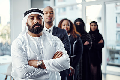 Buy stock photo Cropped portrait of a handsome mature arabic businessman standing at the head of a line of his colleagues