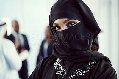 Buy stock photo Cropped portrait of an attractive young arabic businesswoman standing in the office with her colleagues in the background