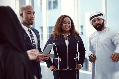 Buy stock photo Cropped shot of a group of diverse business colleagues working together in their corporate office