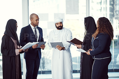 Buy stock photo Cropped shot of a group of diverse business colleagues working together in their corporate office