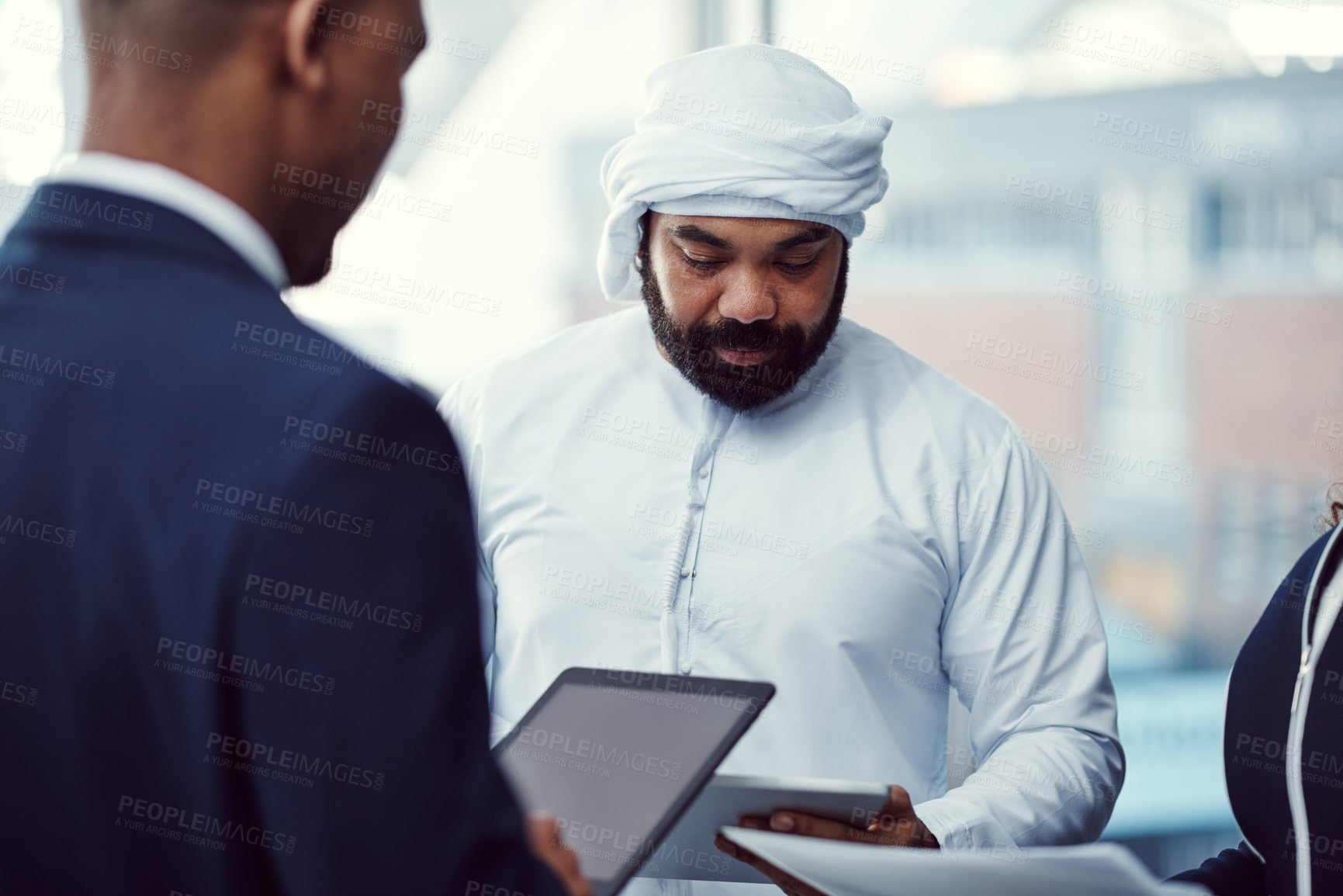Buy stock photo Meeting, team and tablet with business man in office for trading workshop, planning and b2b advisor. Middle east representative, partner and online portfolio manager with employees at expo in Qatar