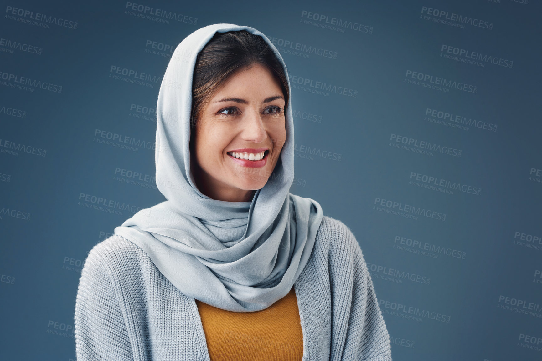 Buy stock photo Thinking, fashion and smile of muslim woman with idea in studio isolated on blue background mockup space. Happy person, Islamic hijab and dream for vision, inspiration or decision with casual clothes