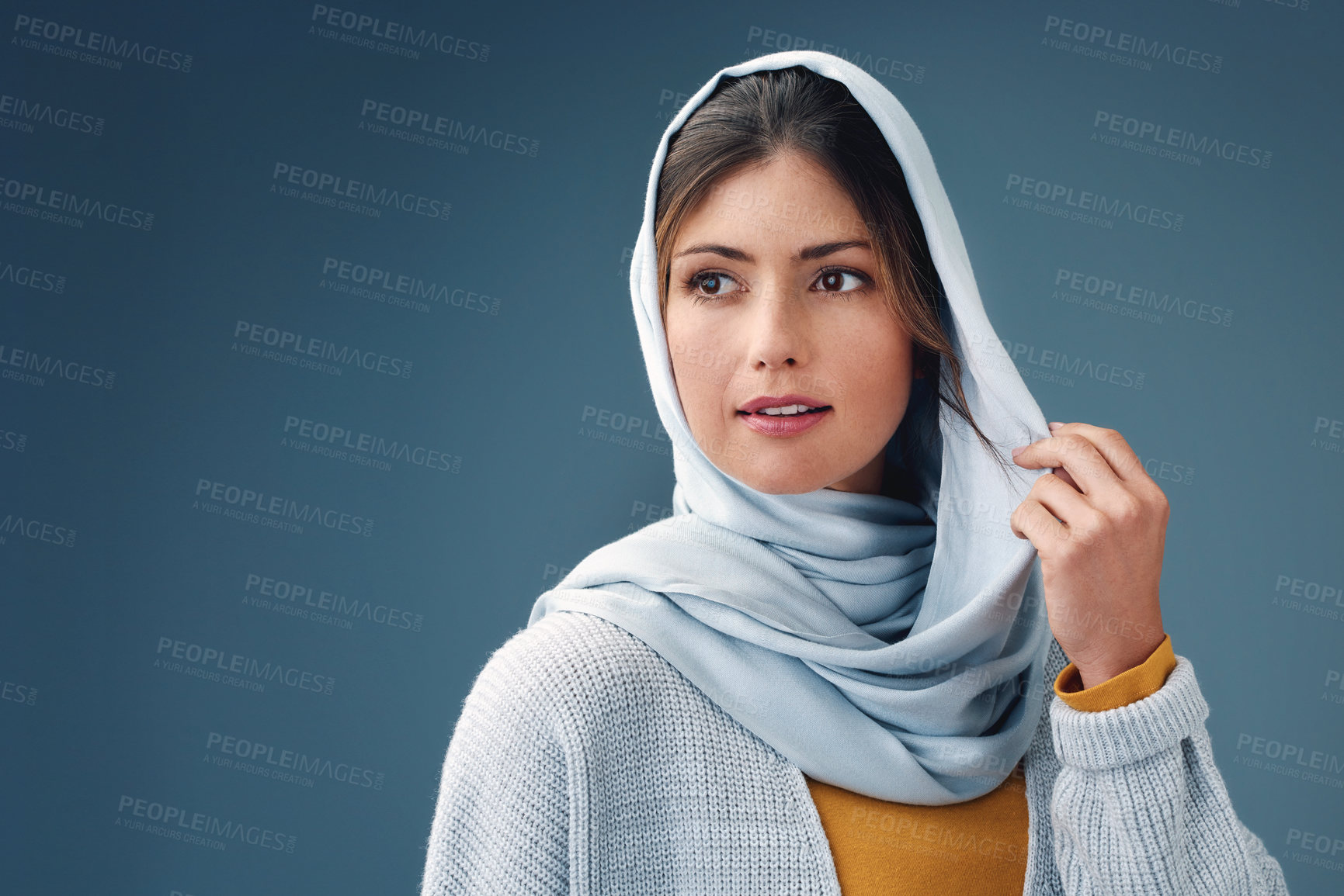 Buy stock photo Thinking, fashion and muslim woman with idea in studio isolated on a blue background mockup space. Serious, dream and Islamic person in hijab for vision, inspiration or decision with casual clothes