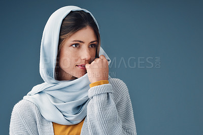 Buy stock photo Thinking, fashion and serious muslim woman with idea isolated on a blue background mockup space. Studio, dream and Islamic person in hijab for vision, inspiration and decision with casual clothes