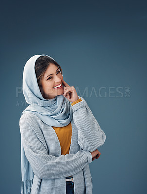 Buy stock photo Smile, thinking and muslim woman with idea in studio isolated on a blue background mockup space. Islamic, dream and happy person in hijab for vision, planning future or decision making for fashion