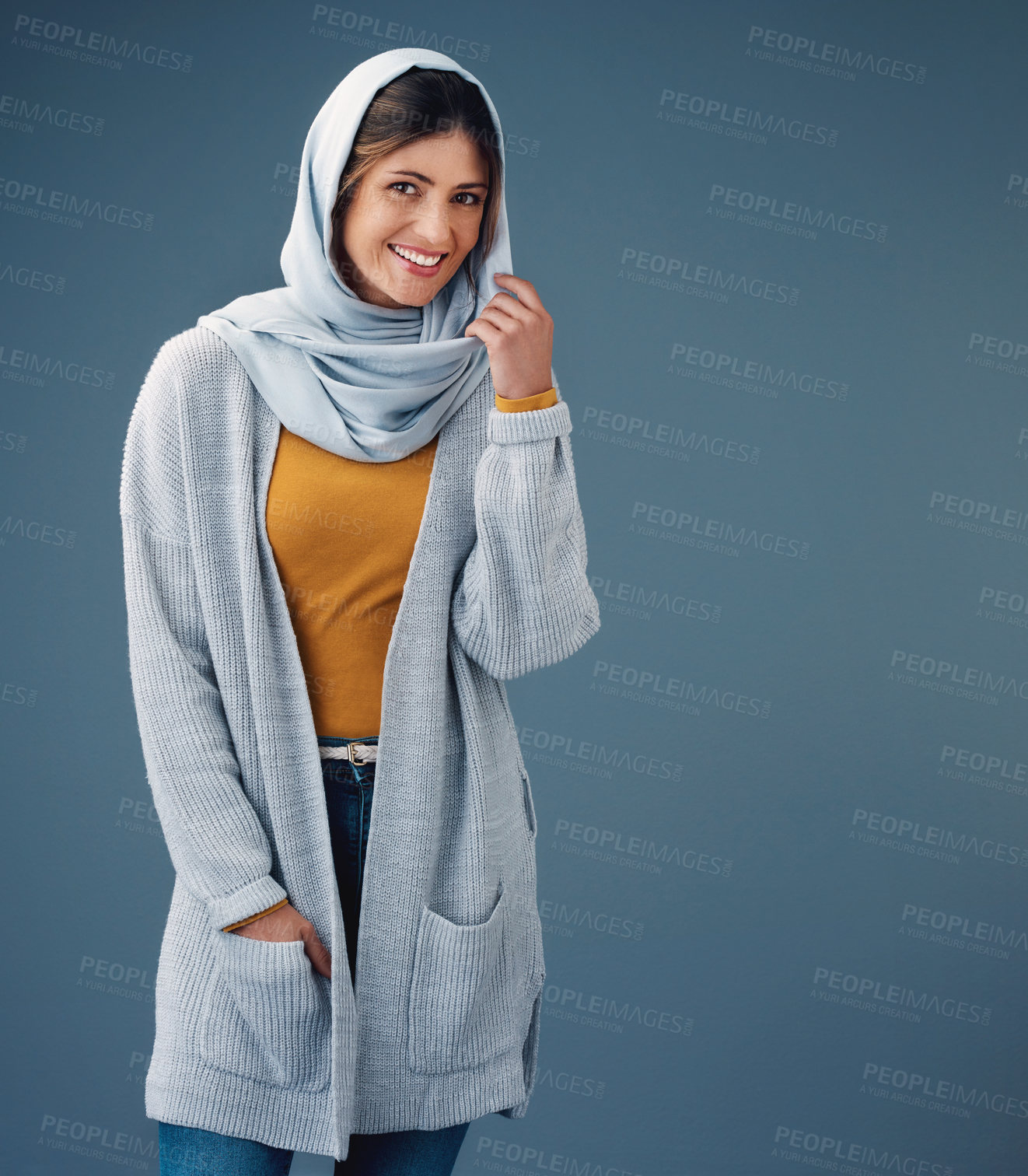 Buy stock photo Happy, studio and fashion with muslim woman, clothes for eid al fitr and modesty for religion and faith portrait. Blue background, chiffon hijab with Saudi model, confident for islamic culture