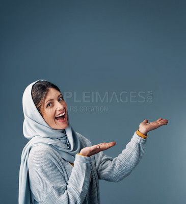 Buy stock photo Muslim, woman and mockup space for advertising, product placement and happiness in studio. Islamic female person, hijab and promotion in studio for marketing, announcement and branding on backdrop.