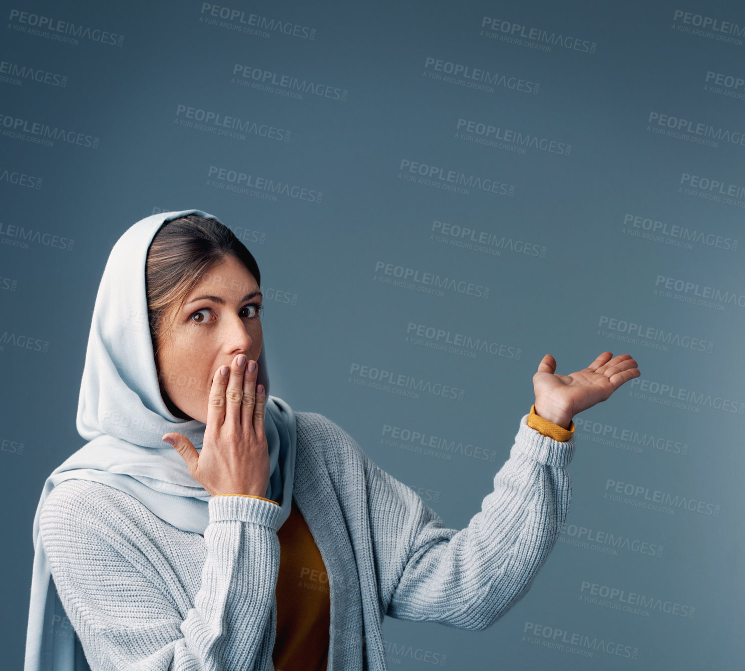 Buy stock photo Cropped portrait of an attractive young woman endorsing your product while standing against a grey background