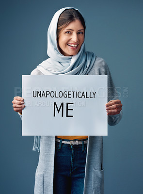 Buy stock photo Muslim, woman and smile with poster in studio on blue background for equality, empowerment and activist. Female person, card and happy in confidence for human rights campaign and advocate in portrait