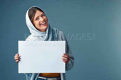 Buy stock photo Sign, mockup and muslim woman in studio, smile and advertising on gray background. Product placement, retail advert and promo deal or sale for Eid holiday, Arabic and hijab for happy female model