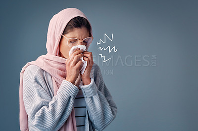 Buy stock photo Flu, sick and woman with hijab in studio with toilet paper allergies and runny nose. Muslim female person, gray background and sinus symptoms for ill health with hayfever, covid 19 virus and sneezing