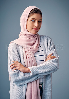 Buy stock photo Woman, studio and arms crossed with hijab in portrait for happy with confidence in islamic culture. Journalist, fashion and middle east on blue background with pride for religion with arabic fabrics